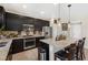 Modern kitchen with stainless steel appliances, dark cabinets, granite countertops, and large island at 44 Moon Hill Dr, Henderson, NV 89011