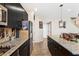 Lovely kitchen features stainless steel appliances, dark cabinets, granite counters, and plenty of storage at 44 Moon Hill Dr, Henderson, NV 89011
