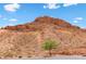 Scenic view of desert landscape features a tree on the side of a mountain, adding natural beauty at 44 Moon Hill Dr, Henderson, NV 89011