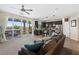 Open-concept living room boasts a ceiling fan and a sliding glass door leading to the patio at 44 Moon Hill Dr, Henderson, NV 89011