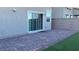 A backyard patio with brick pavers and a patch of green artificial turf at 4752 Cactus Sun Ln, North Las Vegas, NV 89031