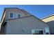 Exterior shot featuring the roofline and stucco walls against a clear blue sky at 4752 Cactus Sun Ln, North Las Vegas, NV 89031