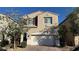 Inviting two-story home with a two-car garage, brick driveway, and desert landscaping at 4752 Cactus Sun Ln, North Las Vegas, NV 89031