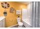 Bright bathroom with cheerful yellow wall, modern toilet, and shower at 5004 Fern Mesa Ave # Lot 137, Las Vegas, NV 89139