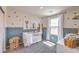 Charming Bedroom with a blue accent wall, a cozy crib, and whimsical animal-themed decor at 5004 Fern Mesa Ave # Lot 137, Las Vegas, NV 89139