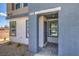 Close-up of a home's entrance, featuring textured walls and a stylish front door with an address marker at 5004 Fern Mesa Ave # Lot 137, Las Vegas, NV 89139
