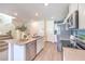 Open kitchen layout with a central island, stainless steel dishwasher, and easy access to the staircase at 5004 Fern Mesa Ave # Lot 137, Las Vegas, NV 89139