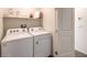 Functional laundry room with a modern washer and dryer and ample shelving for storage at 5004 Fern Mesa Ave # Lot 137, Las Vegas, NV 89139