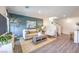 Bright living room with modern decor, wood-look flooring, and a comfortable seating arrangement at 5004 Fern Mesa Ave # Lot 137, Las Vegas, NV 89139