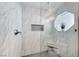 Modern bathroom showcasing a walk-in shower with marble tiles, seating and unique window at 5018 S Rainbow Blvd # 202, Las Vegas, NV 89118