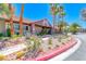 Community clubhouse featuring desert landscaping, cacti and a tiled roof and exterior paint at 5018 S Rainbow Blvd # 202, Las Vegas, NV 89118