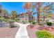 Charming condo with well maintained landscaping, mature trees, and inviting walkway at 5018 S Rainbow Blvd # 202, Las Vegas, NV 89118