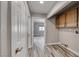 Hallway with hardwood floors, closet, and an adjacent laundry room with cabinets at 5018 S Rainbow Blvd # 202, Las Vegas, NV 89118