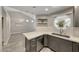 Modern kitchen with stainless steel appliances, white quartz countertops, gray cabinets, and unique window at 5018 S Rainbow Blvd # 202, Las Vegas, NV 89118