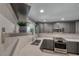 The kitchen offers a stainless steel sink, oven, microwave, quartz countertops, and gray cabinets at 5018 S Rainbow Blvd # 202, Las Vegas, NV 89118