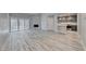 Open floor plan featuring a modern fireplace, fresh paint, wood-look flooring, and plenty of natural light at 5018 S Rainbow Blvd # 202, Las Vegas, NV 89118