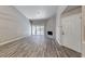 The bright living room has wood-look flooring, a large window, fresh paint, and a stylish fireplace at 5018 S Rainbow Blvd # 202, Las Vegas, NV 89118