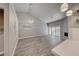 Bright living room with vaulted ceilings, wood floors, modern lighting, and sliding glass doors leading to a balcony at 5018 S Rainbow Blvd # 202, Las Vegas, NV 89118