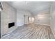 Spacious living room featuring sleek wood-look flooring, a modern fireplace, and recessed lighting at 5018 S Rainbow Blvd # 202, Las Vegas, NV 89118