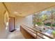 Front door and porch area with a view of lush trees and landscaping at 5018 S Rainbow Blvd # 202, Las Vegas, NV 89118