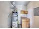 Small utility room with Ruud water heater and wood cabinetry at 5018 S Rainbow Blvd # 202, Las Vegas, NV 89118
