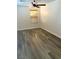Room with wood-look floors, ceiling fan, base molding, and a window with wood-toned blinds at 5055 Lime Kiln Ave, Las Vegas, NV 89139