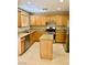 Functional kitchen featuring wooden cabinets, granite countertops, stainless steel appliances, and a central island at 5055 Lime Kiln Ave, Las Vegas, NV 89139