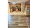 Open-concept living room with wood floors, seamlessly connecting the kitchen and staircase with a modern design at 5055 Lime Kiln Ave, Las Vegas, NV 89139