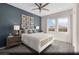 Comfortable secondary bedroom with blue accent wall, plush carpeting, and ample natural light at 516 Hamilton Dr # Lot 25, Mesquite, NV 89027