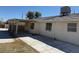 View of the exterior with a covered patio, concrete pathway, and a white painted exterior at 5170 S Pearl St, Las Vegas, NV 89120