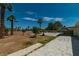 Spacious backyard featuring mature trees, a patio area, and a lawn at 5170 S Pearl St, Las Vegas, NV 89120