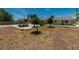 Large backyard with desert landscaping, shade trees, and a concrete picnic table at 5170 S Pearl St, Las Vegas, NV 89120