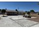 View of the exterior featuring a concrete patio with picnic table and trees at 5170 S Pearl St, Las Vegas, NV 89120