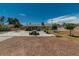 Expansive backyard with desert landscaping, a concrete patio, and mature trees at 5170 S Pearl St, Las Vegas, NV 89120