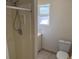 Bathroom with shower, window, toilet, and vanity with storage at 5170 S Pearl St, Las Vegas, NV 89120