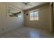 Comfortable bedroom features tile floors, a ceiling fan, and a well-lit window at 5170 S Pearl St, Las Vegas, NV 89120