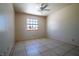 Tranquil bedroom featuring tiled floors, a ceiling fan, and natural light from the window at 5170 S Pearl St, Las Vegas, NV 89120
