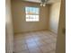 Bright bedroom with tile flooring, ceiling fan and natural light from a large window at 5170 S Pearl St, Las Vegas, NV 89120