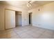 Cozy bedroom with tiled flooring, closet space, and natural light at 5170 S Pearl St, Las Vegas, NV 89120