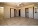 Bedroom with tile flooring, ceiling fan, and closet with sliding doors at 5170 S Pearl St, Las Vegas, NV 89120