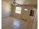 Cozy bedroom with a ceiling fan, window and light tile flooring at 5170 S Pearl St, Las Vegas, NV 89120