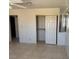 Bedroom with neutral tile, closet with shelving, and large mirrored wall at 5170 S Pearl St, Las Vegas, NV 89120