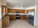 Kitchen area with stainless steel appliances, granite countertops, and wood cabinets at 5170 S Pearl St, Las Vegas, NV 89120