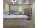 Bright kitchen with a breakfast bar, tile countertops and stainless steel refrigerator at 5170 S Pearl St, Las Vegas, NV 89120