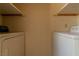 Functional laundry area with washer and dryer hookups and storage shelves at 5170 S Pearl St, Las Vegas, NV 89120