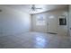Bright living room with tile floors, ceiling fan and a window letting in natural light at 5170 S Pearl St, Las Vegas, NV 89120