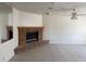 Spacious living room with a brick fireplace, tile flooring, and a ceiling fan at 5170 S Pearl St, Las Vegas, NV 89120