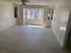 Living room area with neutral colored tile, recessed lights, and big bright windows at 5170 S Pearl St, Las Vegas, NV 89120