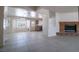 Open-concept living room with tile flooring and a brick fireplace at 5170 S Pearl St, Las Vegas, NV 89120