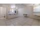 Bright open-concept living room with tile floors flowing into the kitchen at 5170 S Pearl St, Las Vegas, NV 89120